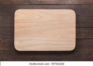 Cutting Board On The Wooden Background. Top View.