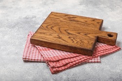 Empty wooden cutting board on a kitchen table. Top view, copy