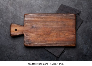 Cutting Board Over Towel On Stone Kitchen Table. Top View Flat Lay