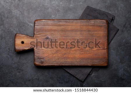 Cutting board over towel on stone kitchen table. Top view flat lay