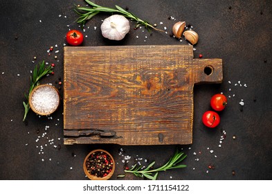 Cutting board and spices for cooking on a stone background