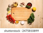 Cutting board surrounded by spices, tomatoes, oil and lemon on wooden table, flat lay. Space for text