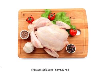 Cutting Board With Whole Raw Chicken And Vegetables On White Background