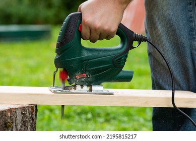 Cutting boards with an electric jigsaw outdoors. - Powered by Shutterstock