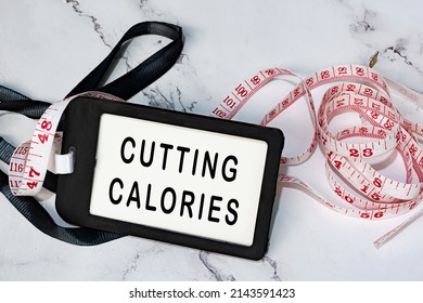 Cutting Calories On Black Name Tag With Measure Tap On White Desk. Healthy And Diet Concept.