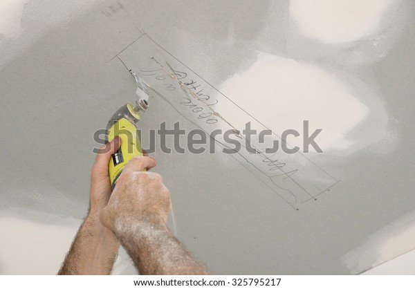 Cutting Ceiling Plasterboard Electrical Multitool Stock