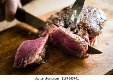 Cutting a cooked steak food photography recipe ide