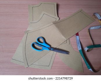 Cutting dress pattern with additional seam allowance.  - Shutterstock ID 2214798729