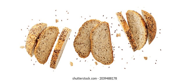 Cutting Fresh Baked Loaf Of Wheat Rye Bread With Crumbs And Various Seeds Flying Isolated On White Background. Top View  Banner