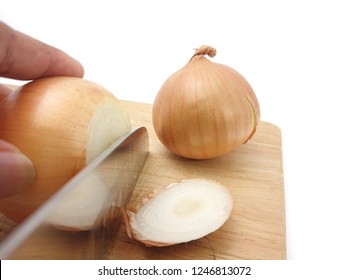 Cutting Of Fresh Onion With Knife On The Wooden Chopper Board