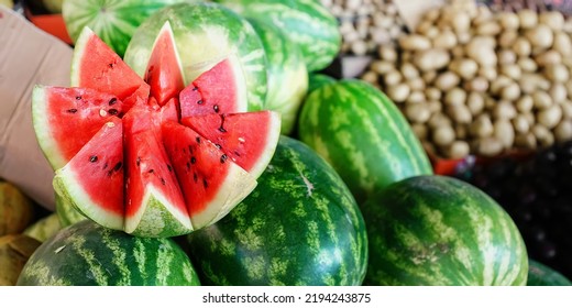 Cutting Fresh Water Melon With Red Succelent Pulp Is Selling At City Market Closeup View