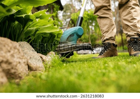 cutting grass with string trimmer. edging lawn