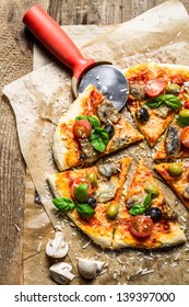 Cutting Homemade Pizza On Old Table