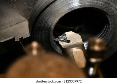 Cutting an internal thread on a slotted nut with a special mechanical cutter on a lathe.