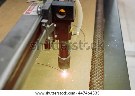 cutting machine carving patterns on the plastic plate. laser machine cutting pattern on acrylic sheet.