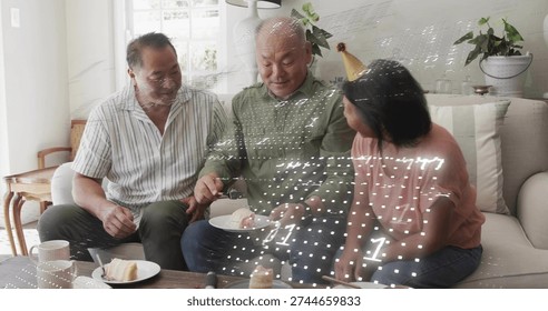 Cutting man serving cake on sofa at home, with plate, cake server and gold party hat. Family, gathering, couch, familylife, candid, decor, daylight