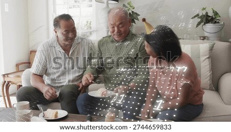 Cutting man serving cake on sofa at home, with plate, cake server and gold party hat. Family, gathering, couch, familylife, candid, decor, daylight
