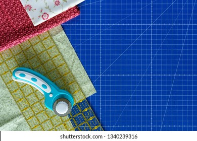 Cutting mat with rolling knife, ruler and pieces of fabric for quilting or patchworking with copy space background - Powered by Shutterstock