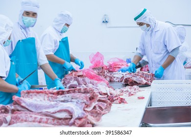cutting meat slaughterhouse workers in the refrigerator