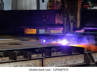 Cutting metal with plasma equipment. Worker cutting steel pipe using metal torch and install roadside fence. Electric sparklers background. - Powered by Shutterstock