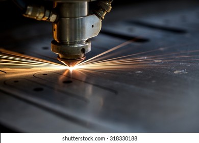 Cutting of metal. Sparks fly from laser - Shutterstock ID 318330188
