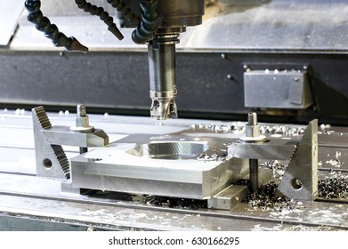 Cutting metalworking process. Square industrial metal mold/blank milling at factory. Mechanical engineering, lathe, drilling industry, CNC technology. Indoors horizontal image.