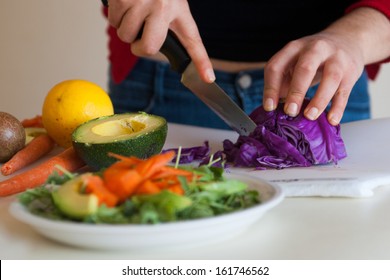 cutting red cabbage for a green salad
