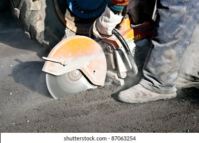 Cutting road works with petrol driven angle grinder