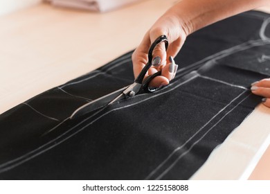 Cutting and sewing. Girl is cutting fabric.  - Powered by Shutterstock