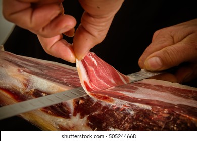 Cutting a slice of iberian ham
