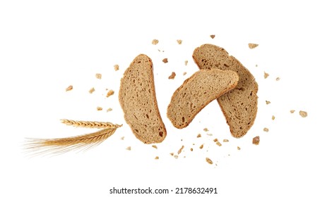 Cutting Slices Of Wheat Rye Bread With Crumbs And Spikelets Flying Isolated On White Background.