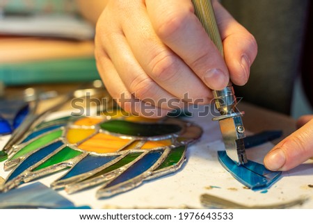 cutting stained glass with a glass cutter, glass scraps, stained glass crafting