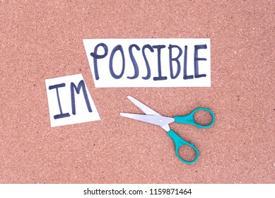 Cutting the word in paper note impossible to read possible, concept for self belief, positive attitude and motivation.
