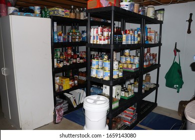 Cuyahoga Falls, OH/USA - 02 28 2020: Prepper Shelves Basement Black With White Buckets Of Food