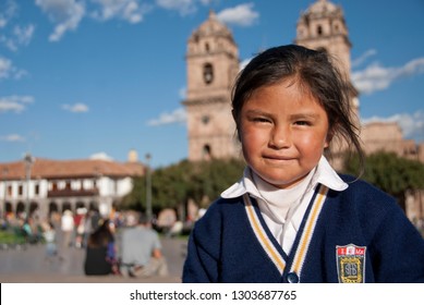 CUZCO, PERU - MAY 7 2010: Unidentified Peruvian School Girl Poses For A Photo At Plaza De Armas In Cuzco, Peru. Peruvian Kids Often Have To Fend For Themselves After School.