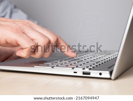 CV, application submission. Man working on laptop and sending curriculum vitae. Male forefinger pressing enter button. Resume uploading concept. High quality photo 商業照片 © 