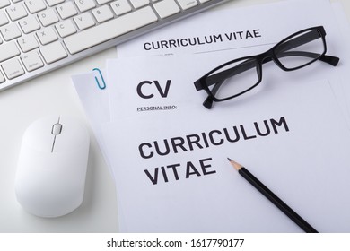 CV, curriculum vitae with computer keyboard and mouse, job interview