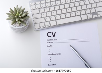 CV With Pen And Computer Keyboard On White Table