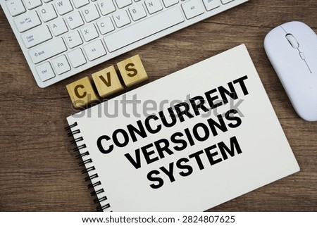CVS Concurrent Versions System message with keyboard and optical mouse on wooden background