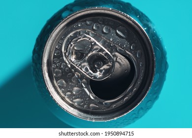 Cyan Blue Open Soda Can In Shadow And Light Covered With Water Drops