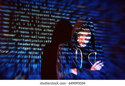 Cyber attack with unrecognizable hooded hacker using virtual reality, digital glitch effect.