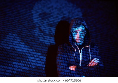 Cyber attack with unrecognizable hooded hacker using virtual reality, digital glitch effect.
