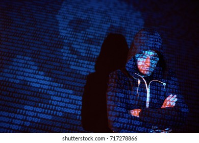 Cyber attack with unrecognizable hooded hacker using virtual reality, digital glitch effect.
