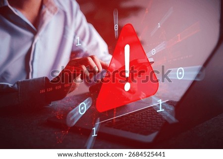 Cyber attack warning alert with red exclamation symbol appearing on laptop screen, representing hacking threat, malware detection, and online system vulnerability.