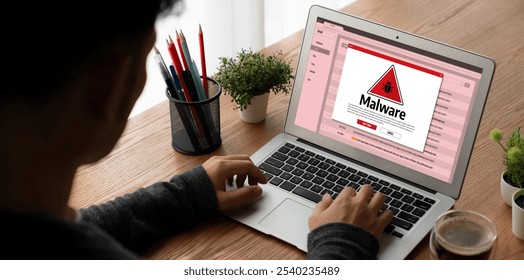 Cyber attacking concept. Malware alert showing on computer screen display scam and threat detection on computer system or online server to be removed snugly. - Powered by Shutterstock - Get 15% off with code: PIKWIZARD15