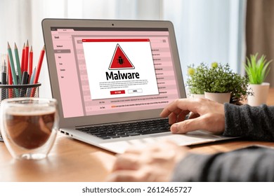 Cyber attacking concept. Malware alert showing on computer screen display scam and threat detection on computer system or online server to be removed snugly.
