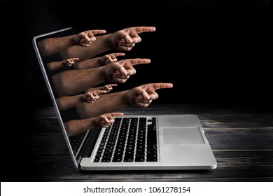 Cyber bulling concept with fingers from the screen blame user - Shutterstock ID 1061278154