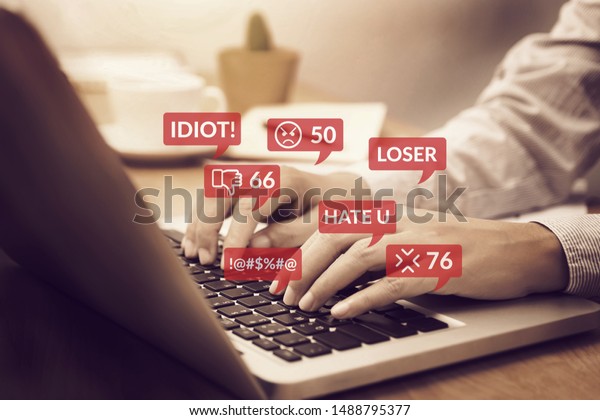 cyber bullying concept. people\
using notebook computer laptop for social media interactions with\
notification icons of hate speech and mean comment in social\
network