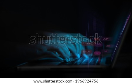 Cyber Bullying and Racist via Internet Concept. World Social Issue. Motion Blurred image of Person Using Computer Laptop to making Others feeling Sad by Bad Message. Parody and Intimidation
