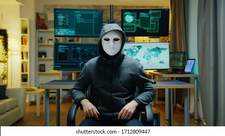 Cyber Criminal Wearing A White Mask Using Augmented Reality To Steal Secret Information.